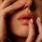 Close up woman hands touching face