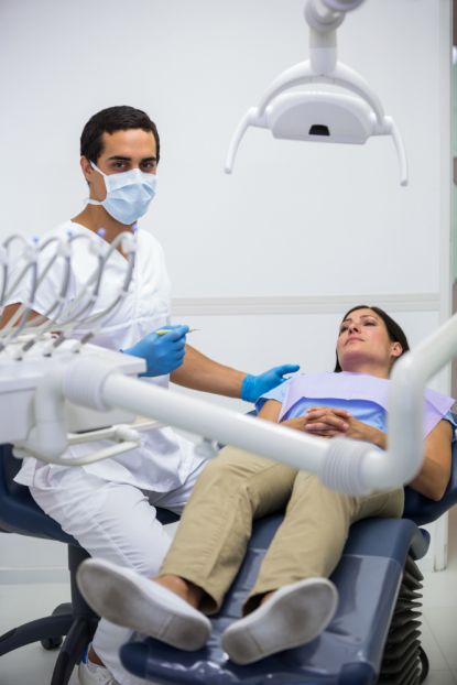 dentist treating female patient at the clinic
