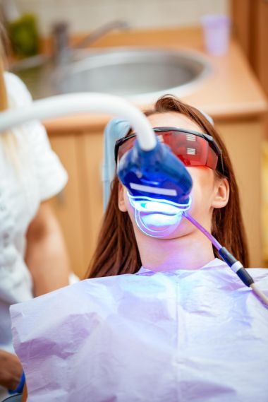 woman in a dentist chair having her teeth whitened