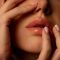 Close up woman hands touching face
